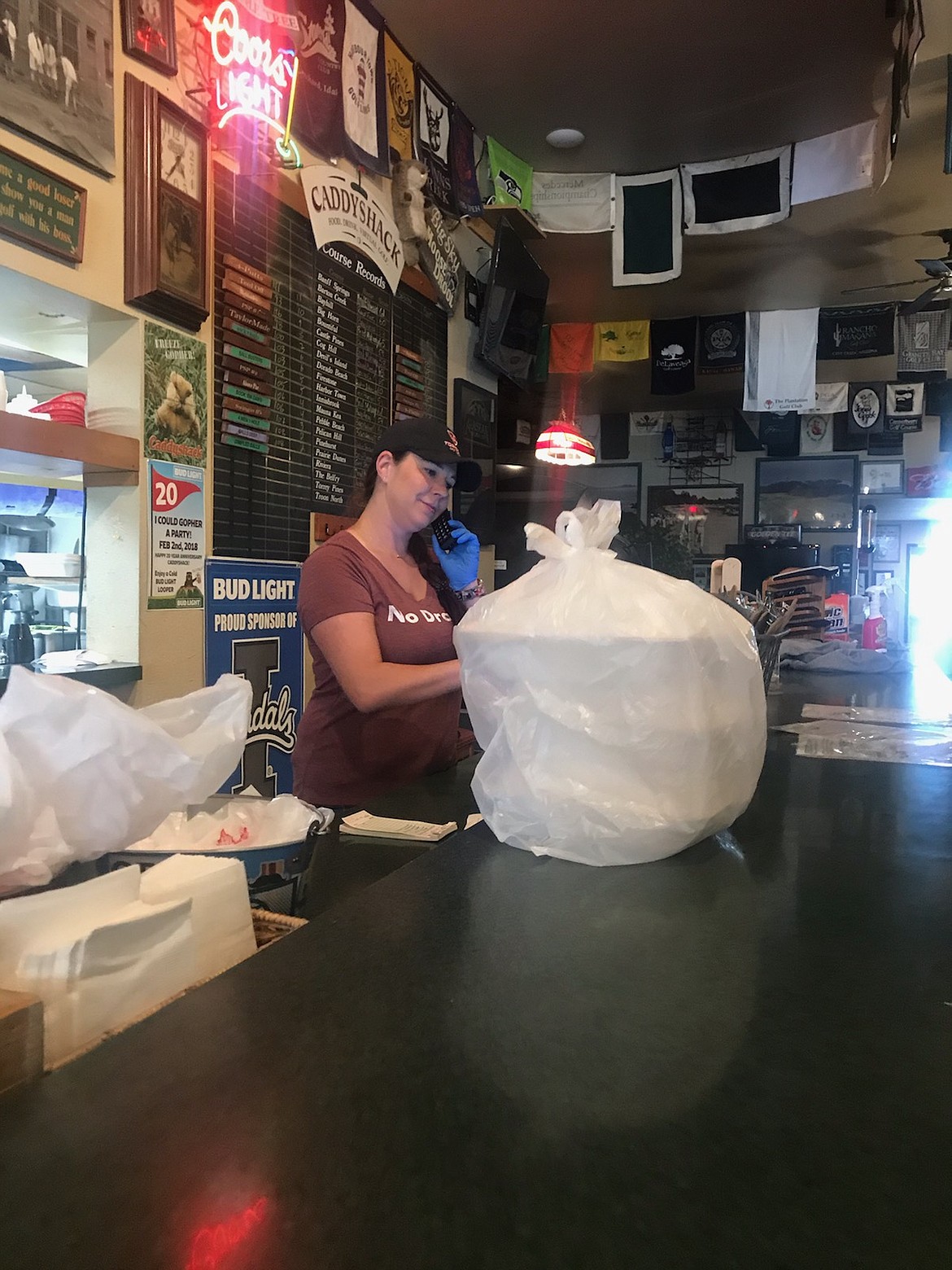 Veronica French and the rest of the staff at Caddyshak on Prairie Avenue have managed to stay busy with curbside service during the coronaviurs pandemic. Governor Brad Little won't open bars, taverns and nightclubs to the general public until mid-June. (Photo by Johnny French)