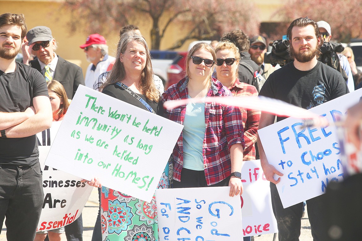 BILL BULEY/Press 
 Some of the crowd who turned out for Sunday's rally listen to speakers in the old Shopko parking lot.