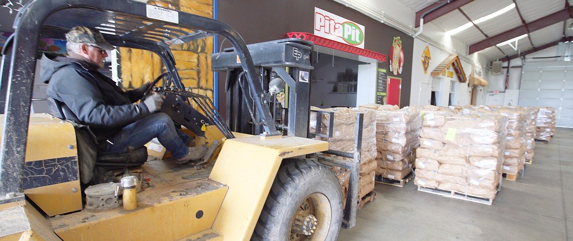 BILL BULEY/Press 
 Allan Dykstra, facilities manager at the Kootenai County Faigrounds, moves potatoes into a buiding on Monday.