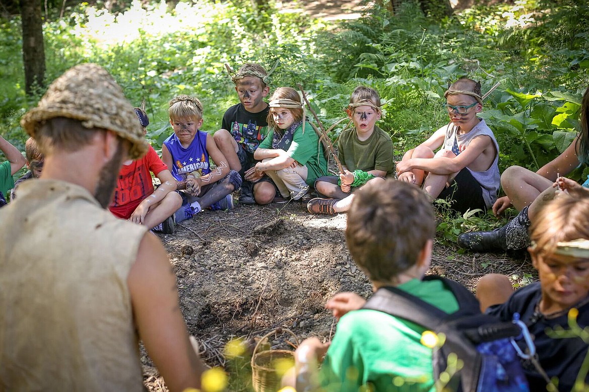 Area youth take part in an education activity at the Pine Street Woods, an 180-acre property acquired in the last year by the Kaniksu Land Trust, with help from a host of donors and citizens.