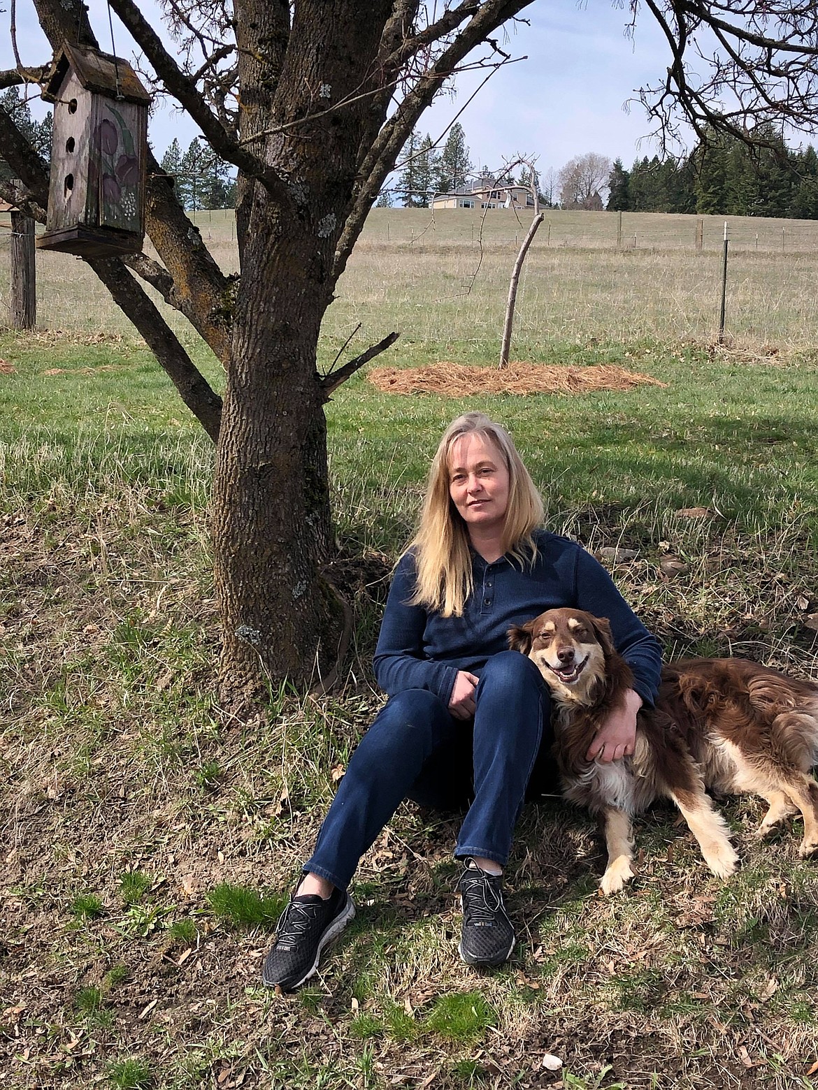 Opal Harbert and Buck relax on the family’s property in Mead, Wash. (Photo by SHELLEY RUSS)