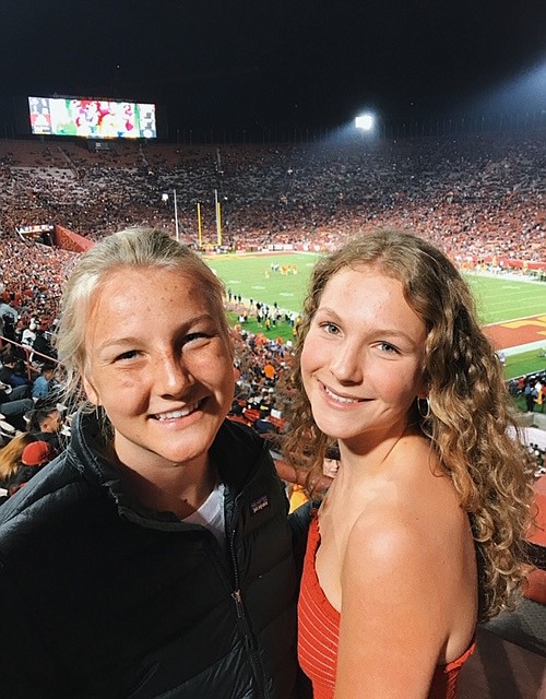 Elisa James, left, and sister Catherine James watch a football game at the University of Southern California in October 2017. Catherine is following in her sister’s academic footsteps as she will graduate from Lake City High at the top of her class with a 4.5 GPA in June. Elisa graduated from the same school with the same GPA in 2017. (Courtesy photo)