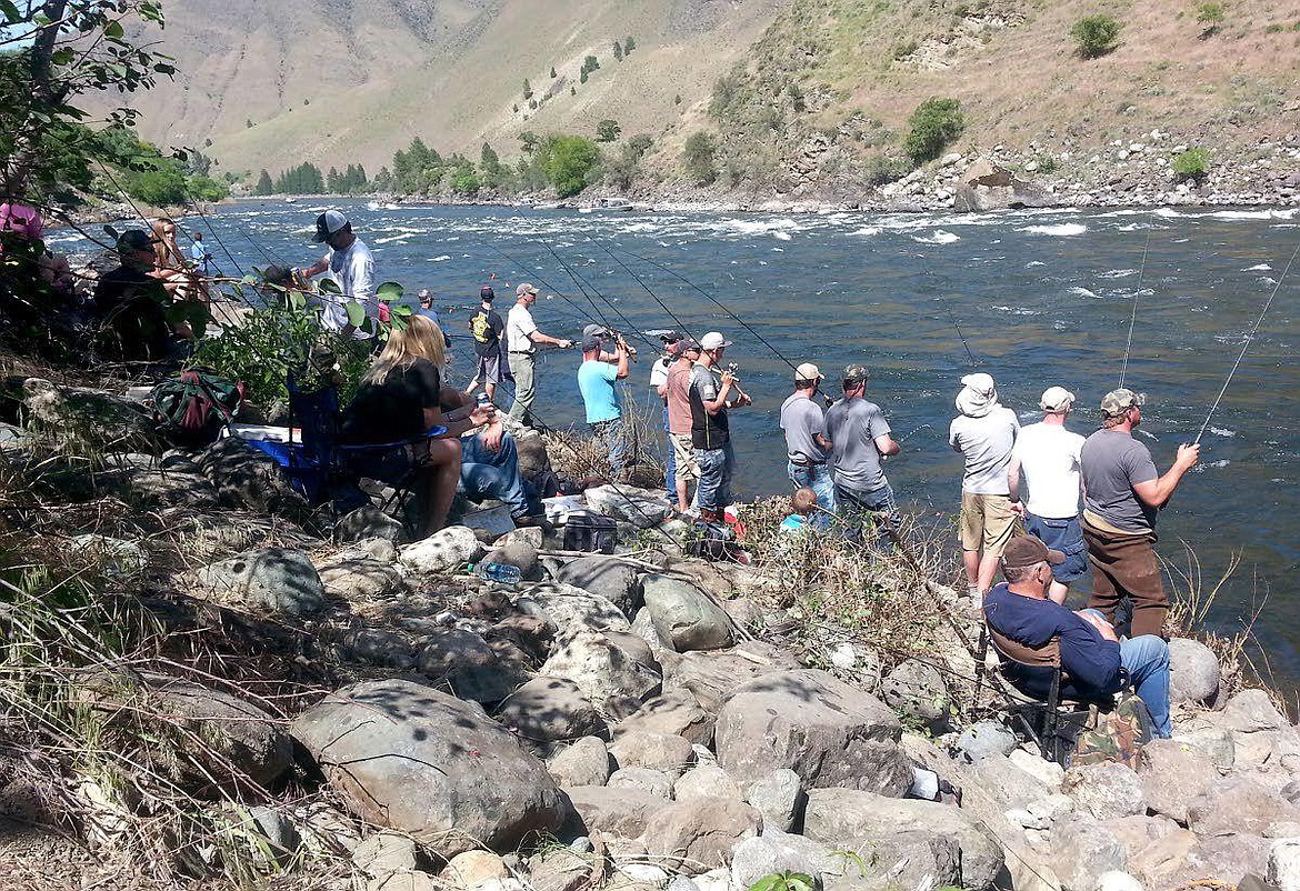 Anglers stand shoulder to shoulder while fishing the popular Boulder Hole near Riggins in this old photo. Fish and Game plans to monitor fishing sites this spring to enforce the governor’s social distancing order.