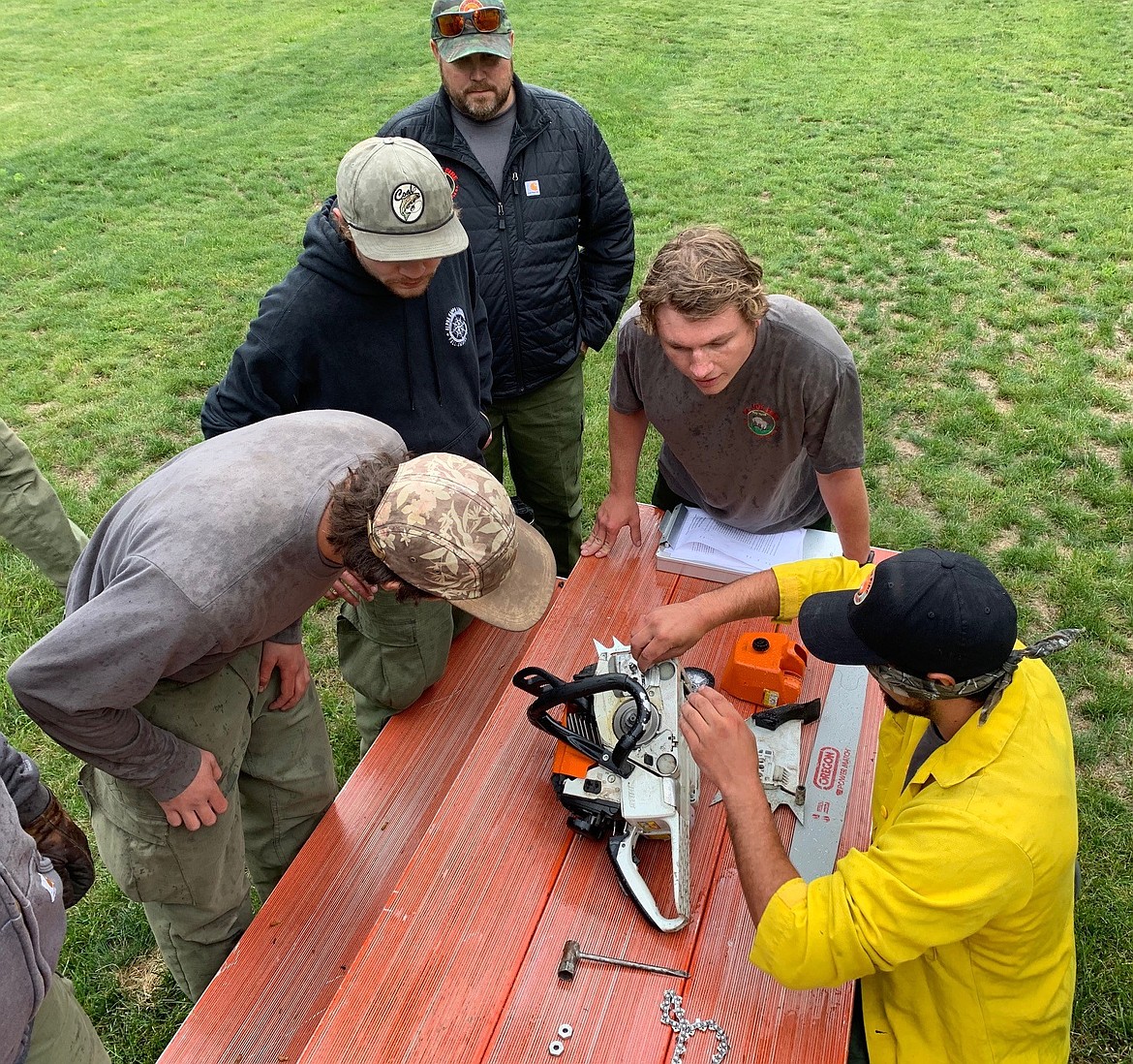 Wildland firefighters on the St Joe Ranger District learn how to assemble a chainsaw in prepartion for the wildfire season. Crews this year have taken extra precaution against COVid-19 while preparing for the season. (Photo Courtesy of the Idaho Panhandle National Forests)