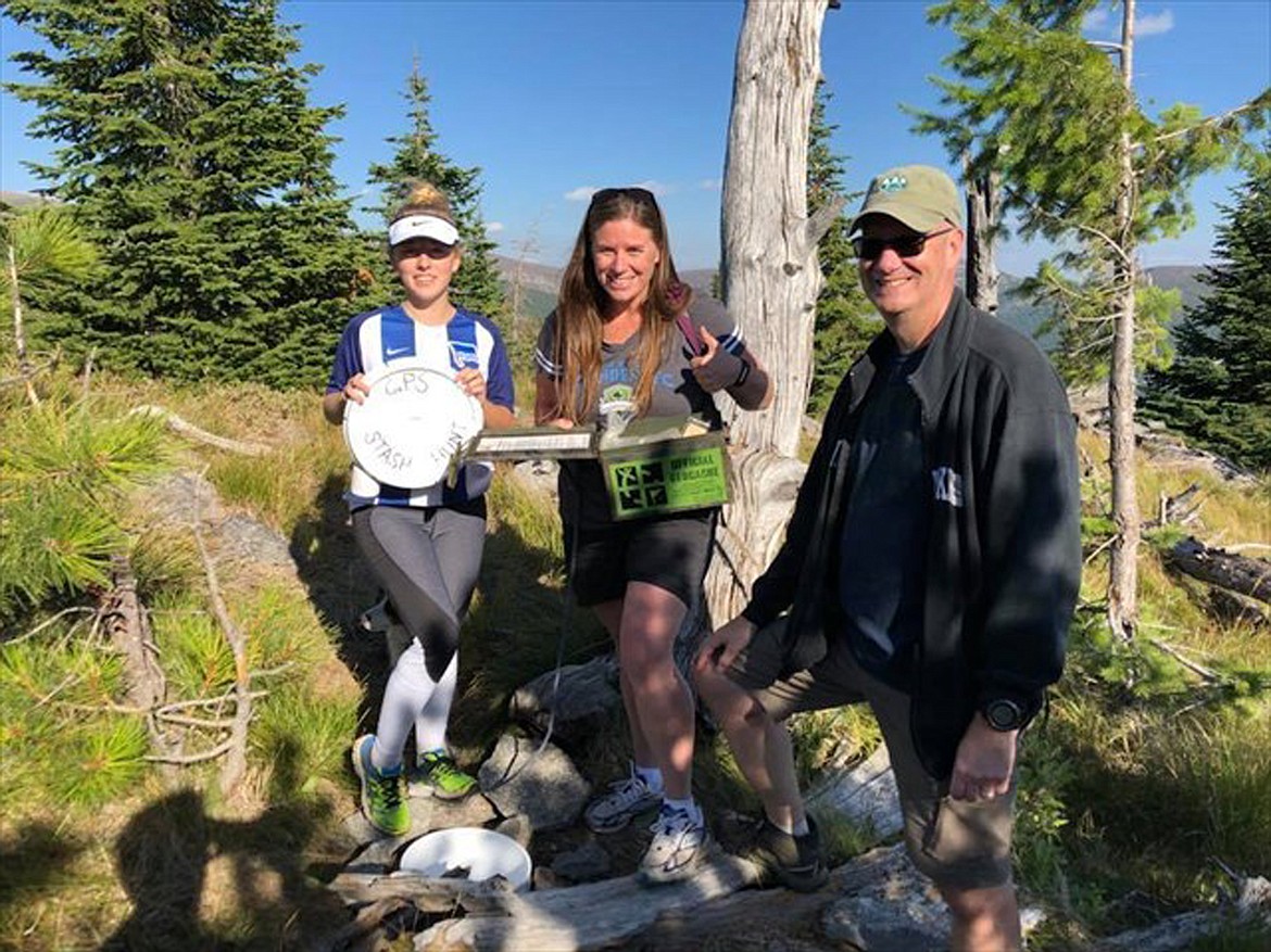 Emma Unger, Annie Love and Jon Stanley, pictured left to right, pose for a photo at the Camels Prairie Stash, Idaho’s first geocache.