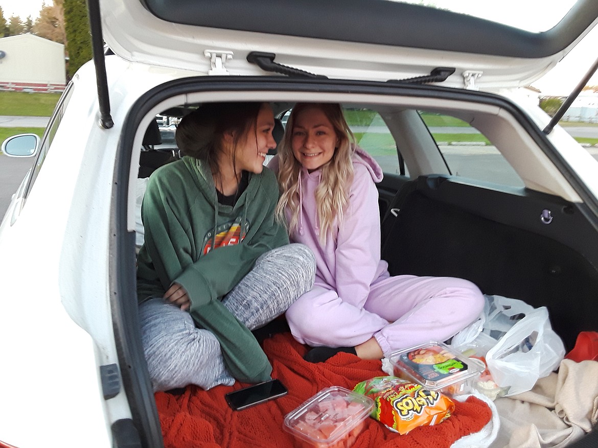 Skye Keough of Hayden (left) and Gabby Cowles off Post Falls decided the hatchback was the perfect way to enjoy the drive-in experience. (CRAIG NORTHRUP/Press)