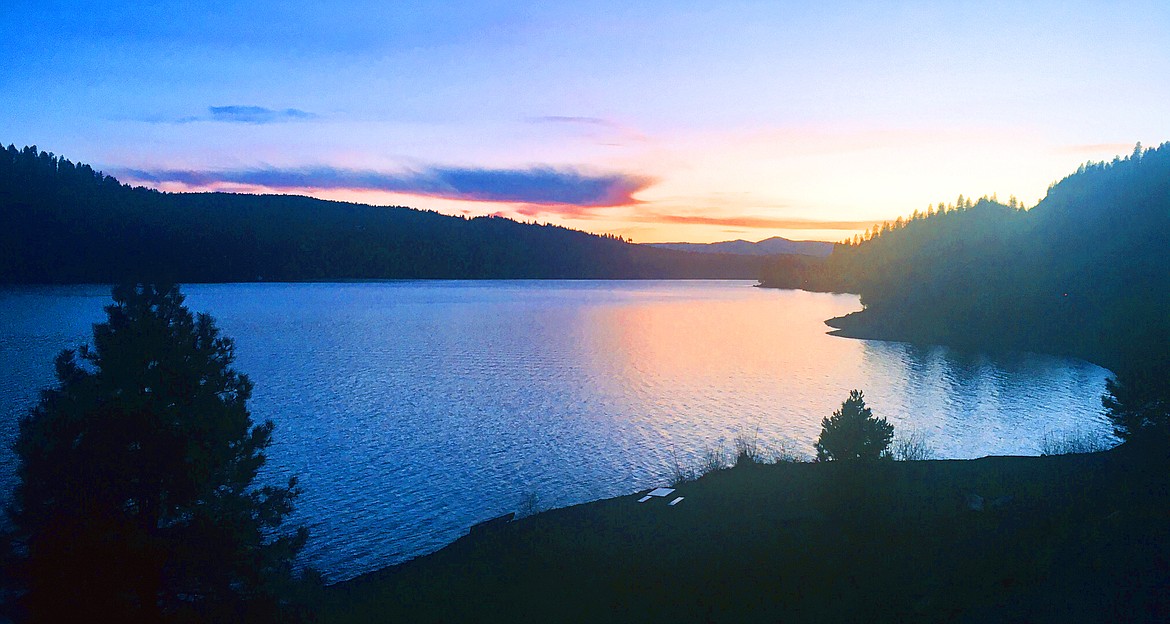 The setting sun casts its glow over Lake Coeur d’Alene in this view from Higgens Point.