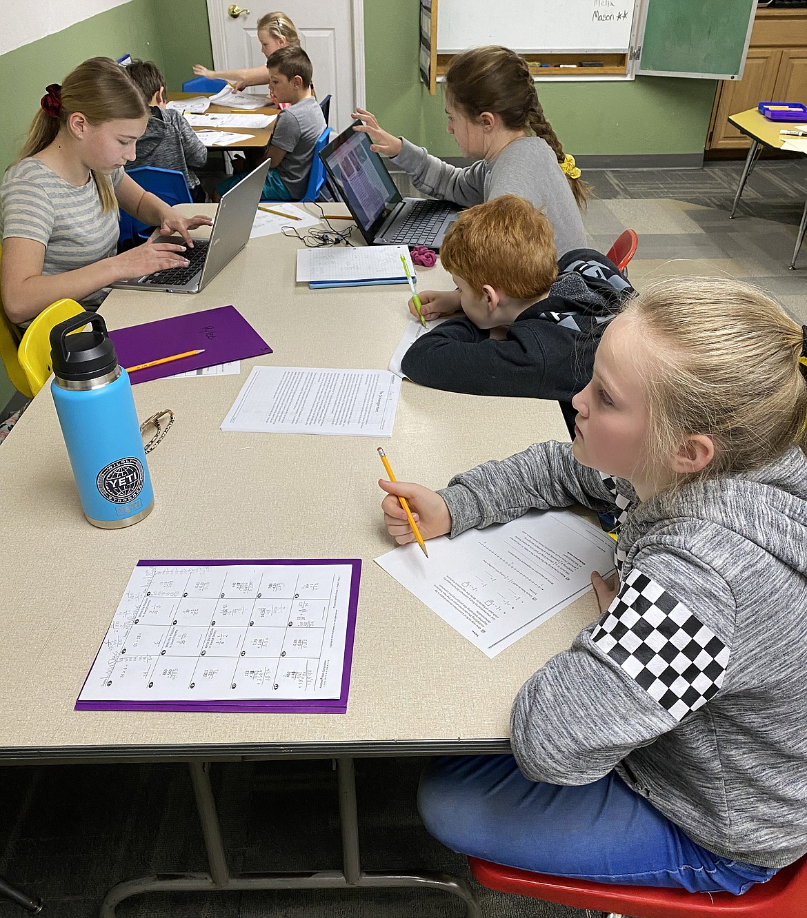 Kids chip away at school work while at River City Rascals in Post Falls last month. River City Rascals was one of several child care centers or programs that received grant funds from the Coeur d’Alene COVID-19 Relief Fund. From left, clockwise: Post Falls Middle School student Emma Geary, 12; Post Falls Middle Schooler Taytum Rice, 12; Greensferry Elementary student Jasper Wetherelt, 10; and West Ridge Elementary schooler Kiana Dehlbom, 11.