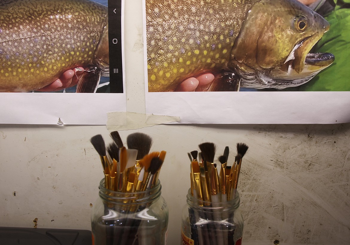 Above: For a recently completed project, a large brook trout, Ford used a cell phone image and his own artistry to reproduce a wall hanger of the 26-inch brookie for a client.
Left: Ford combines paints, blushes and heat with purchased parts to reproduce fish that seem to swim on a wall.