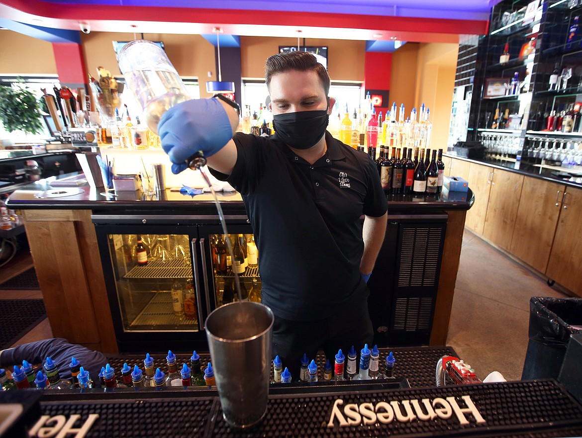 BILL BULEY/Press 
 Daniel Bentley pours a drink at Seasons of Coeur d'Alene on Saturday.