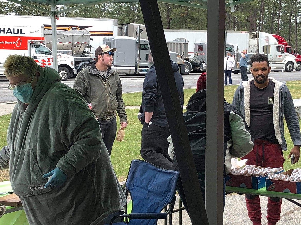 (Photo courtesy KENDRA DODGE) 
 Volunteers serve a free meal to truckers to thank them for being COVID-19 superstars and helping keep the stores full.
