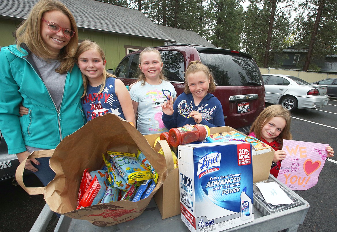 BILL BULEY/Press 
 Ginger Cooper and daughter Kaitlyne, Sarah, Brittany, and Mackenzie deliver food and supplies to Children's Village on Tuesday. Brittany led fundraising efforts to help the kids at Children's Village.