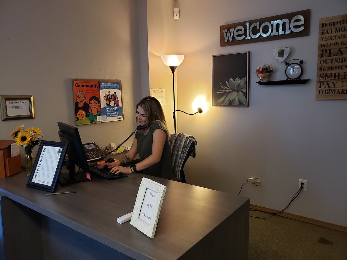 Safe Passage Violence Prevention Center advocate Ashley Vandergrift takes a phone call in the Coeur d'Alene office. The Innovia Foundation is a supporter of Safe Passage, recently providing a $3,000 grant that was used to provide shelter for an increased number of domestic violence victims. (Courtesy photo)