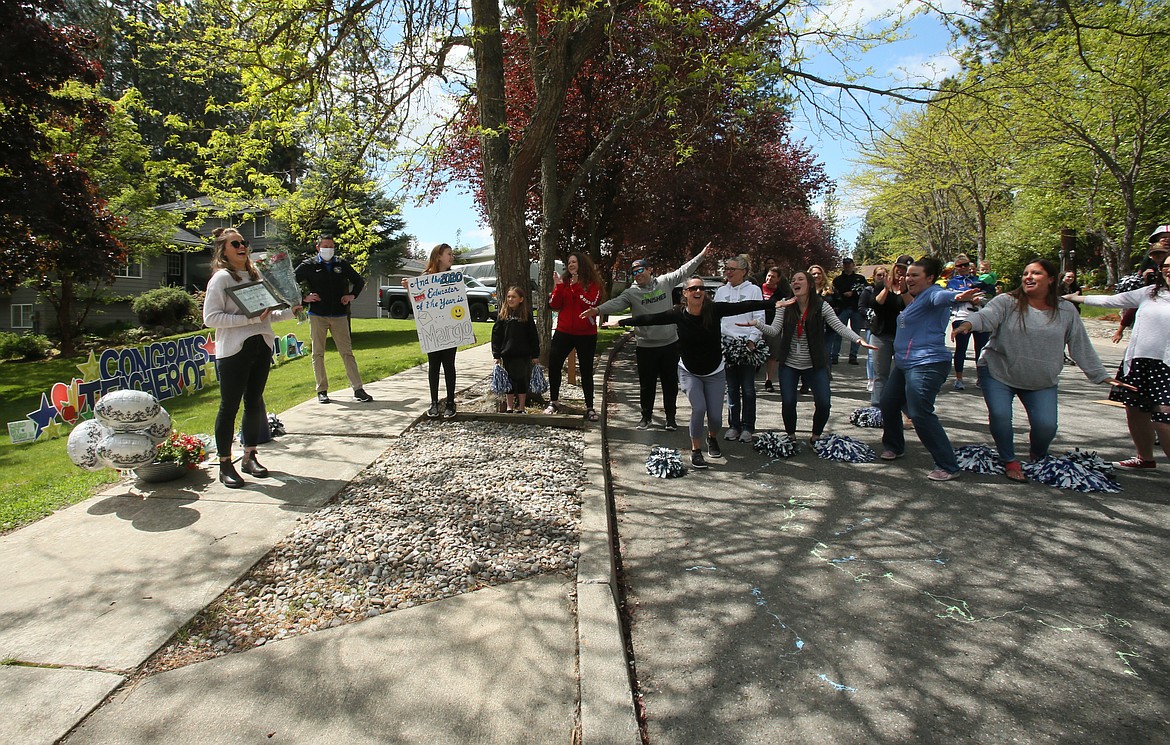 Margo Swanson's friends and colleagues celebrate her Teacher of the Year honors during a surprise celebration outside of her Coeur d'Alene home on Thursday. Swanson, far left, is an eighth grade teacher at Lakes Middle School. (DEVIN WEEKS/Press)