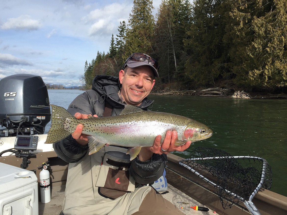 M. Koenig is pictured with a rainbow trout caught on the Clark Fork River.