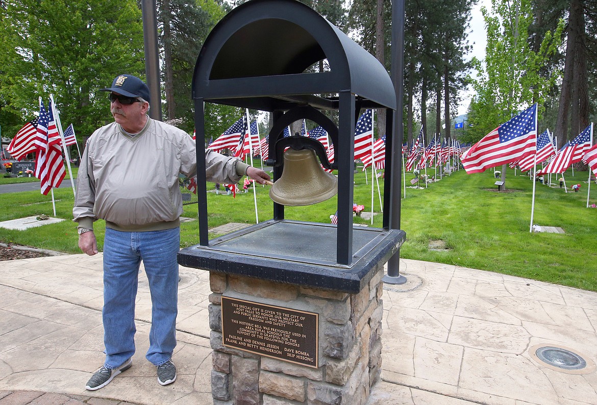 BILL BULEY/Press 
 Bill Carlson rings the bell as the names of veterans who have fallen since Memorial Day 2019 are called on Monday at Evergreen Cemetery.