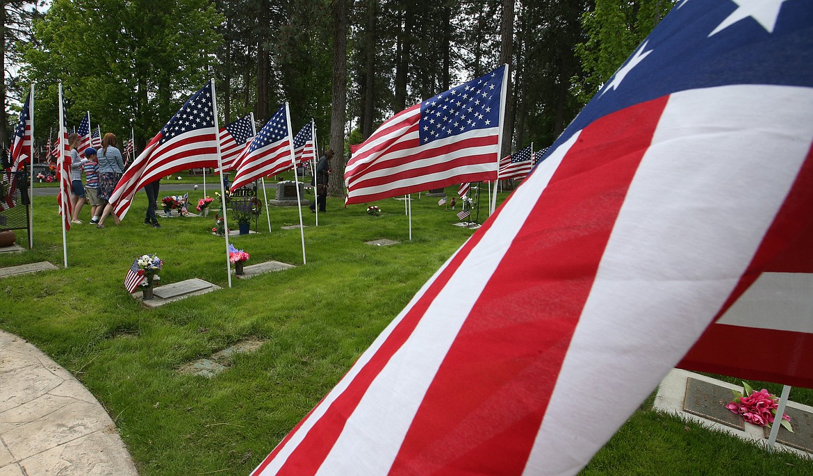 BILL BULEY/Press 
 People walk through Evergreen Cemetery following Monday's Memorial Day ceremony.