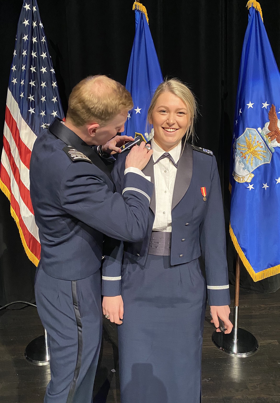 Brenden May pins United States Air Force Academy graduate Erin Hague with her second lieutenant rank after being commissioned as an officer in April. "It is typical that you would have your family or people who mean something to do that for you when you promote," Hague explained. "Because our families couldn't be there, we chose out of our close friends at school. Brenden is actually my boyfriend and had commissioned that same day. I pinned on his shoulder boards right after he pinned mine on." (Courtesy photo)