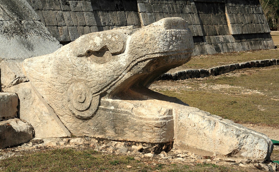 WIKIMEDIA COMMONS 
 Mayan dragon Kukulkan at the base of the west face of the northern stairway of El Castillo, Chichen Itza, Mexico.