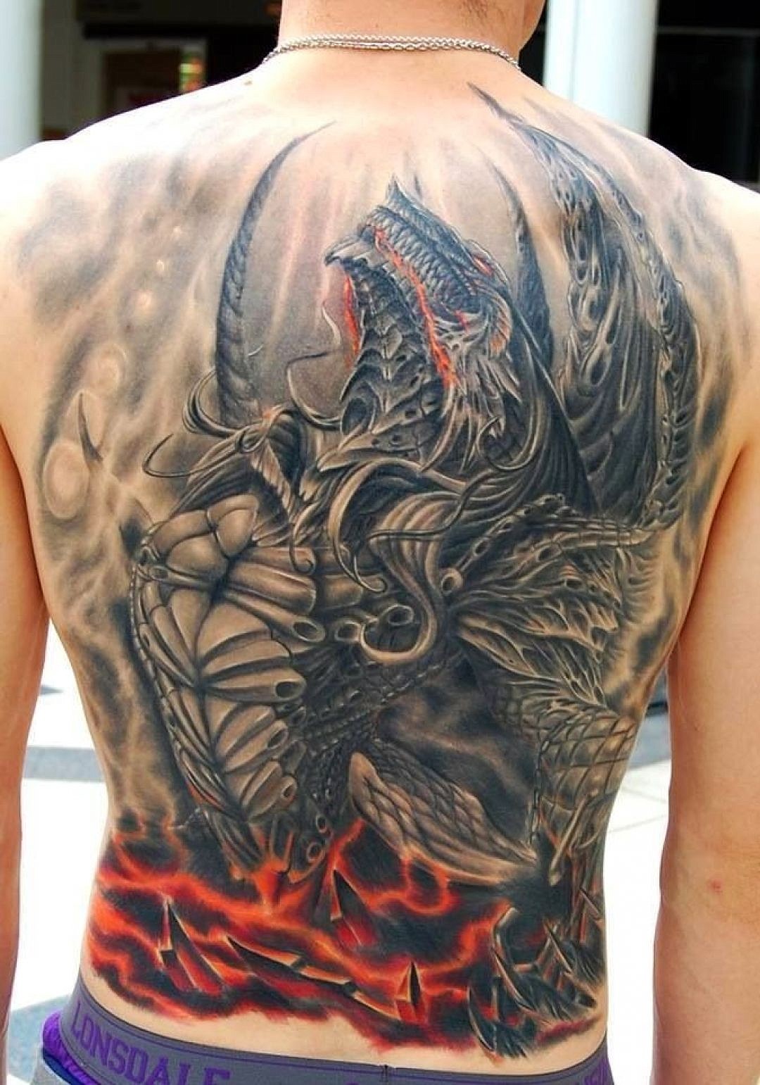 99IMAGES.COM 
 Tattoo of an evil dragon.