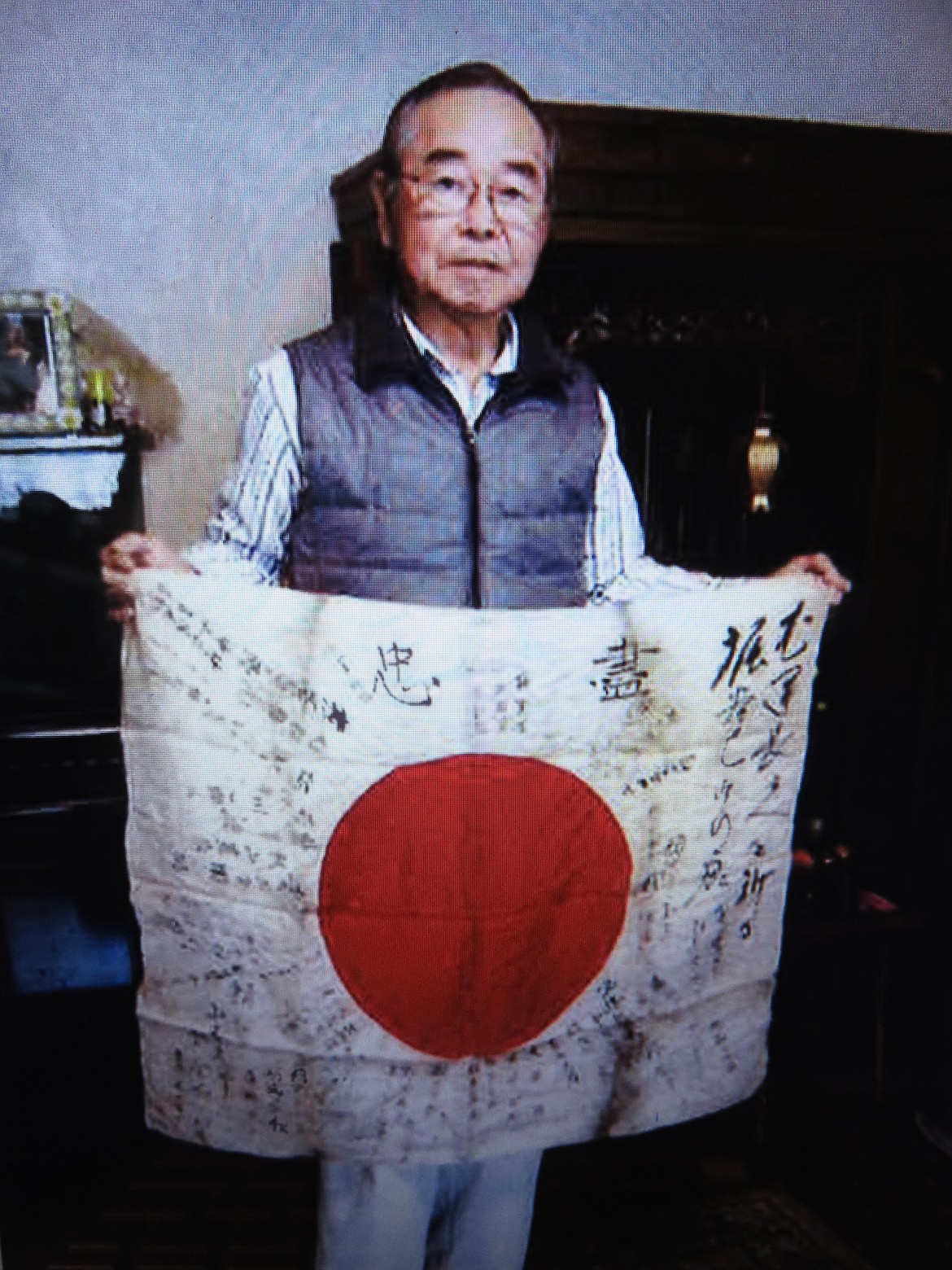 Noboru Horiya with the flag of his father, after it was returned to him by St. Maries American Legion Post 25 earlier this year.  Courtesy photo
