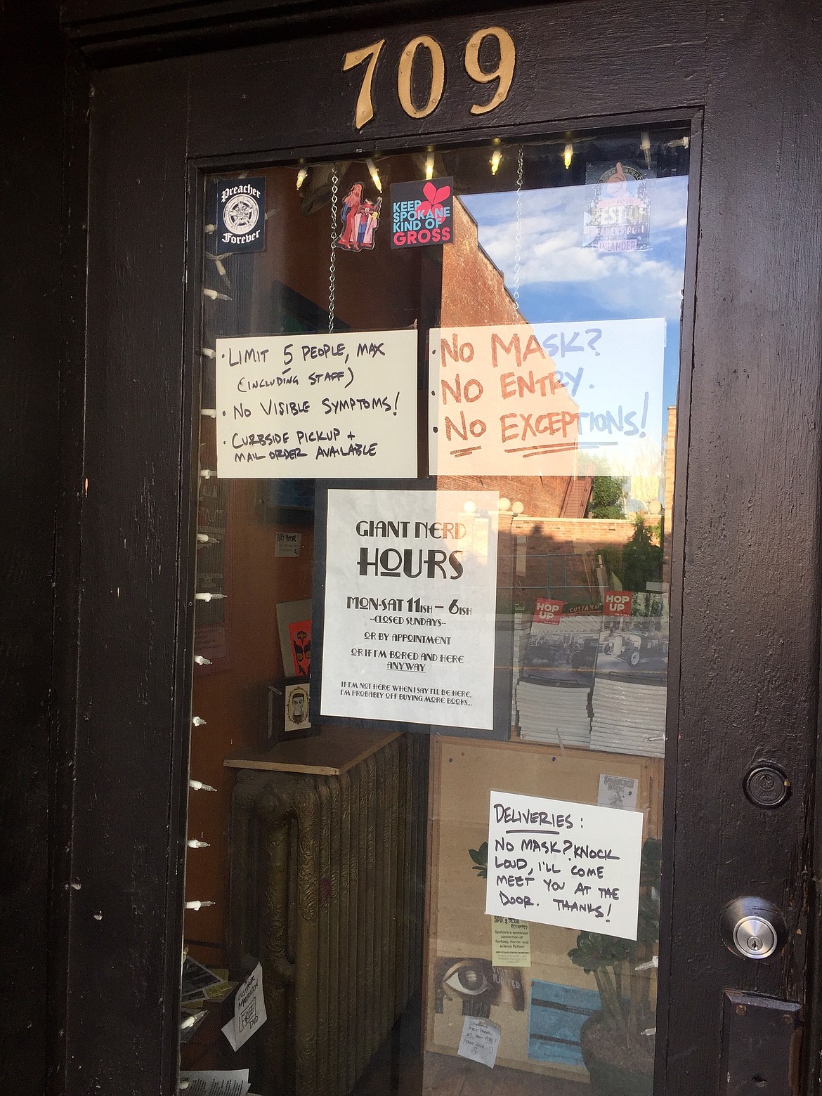 Strict rules guide shoppers at Giant Nerd Books in Spokane. Owner Nathan Huston has had to turn several customers away for refusing to wear facemasks, but most patrons have been grateful for the precautions being taken in the store. (JENNIFER PASSARO/Press)