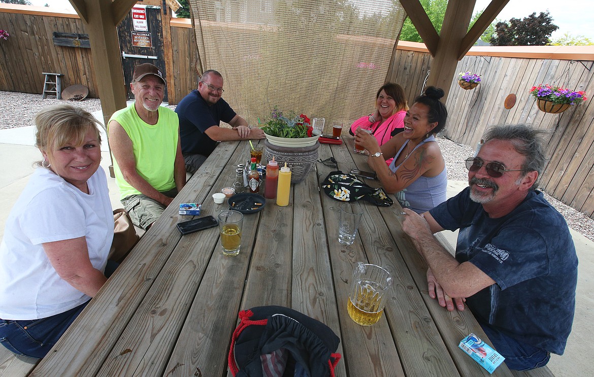 BILL BULEY/Press 
 Friends in the outside beer garden enjoy the reopening of the Falls Club on Saturday. Clockwise from left, Cathy Quinn, Mike Sparkman, Morgan Tanner, Vada Fernandez, Susie Levingston and Tom Angerman