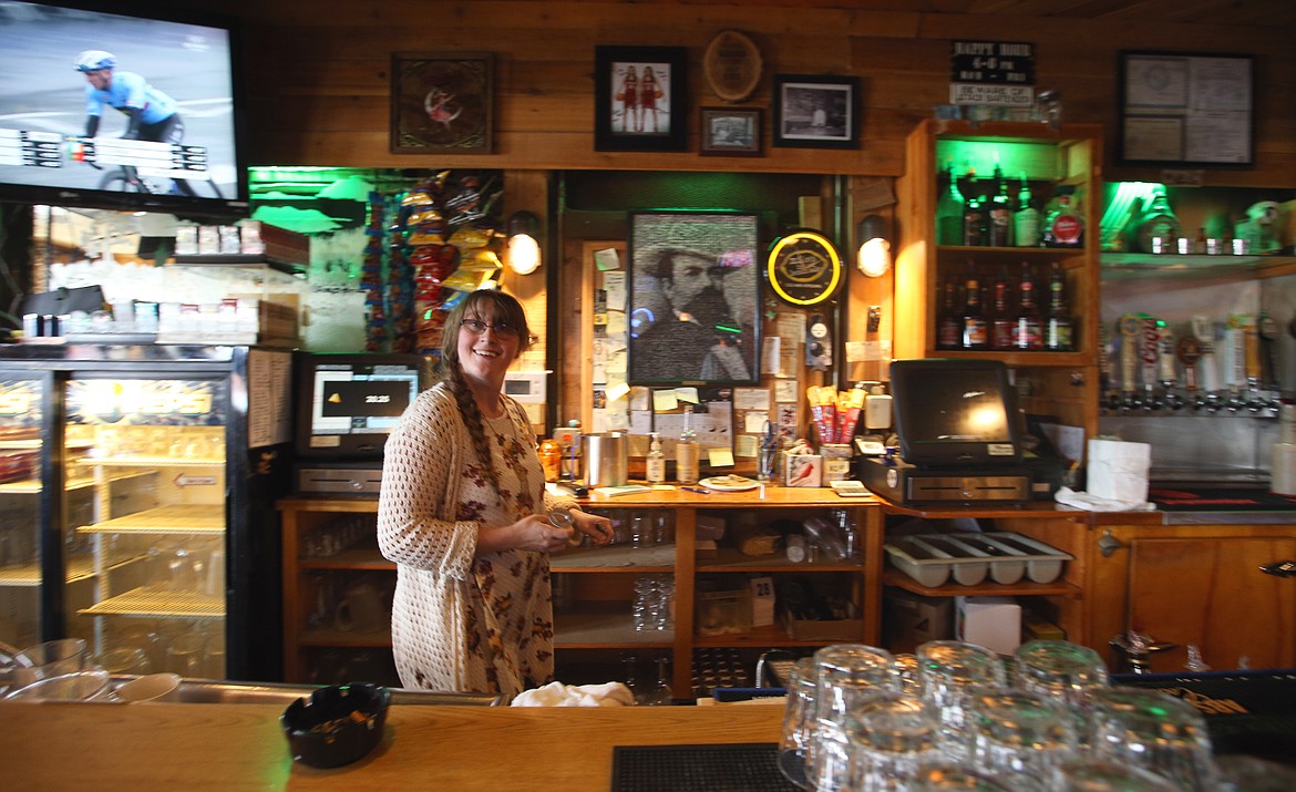 BILL BULEY/Press 
 Falls Club employee Danielle Schaeffer is all smiles as she works behind the bar Saturday afterboon.
