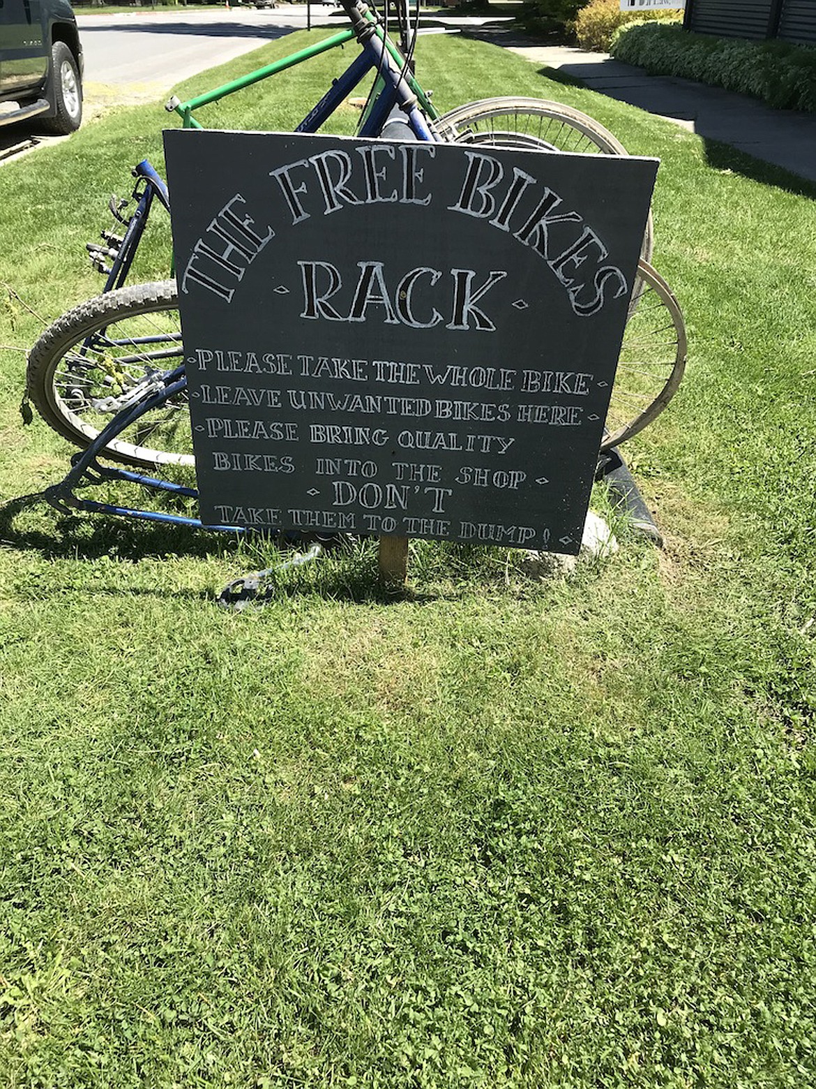 (Photo by SUSAN DRINKARD) 
 A sign at the bicycle shop encourages residents to drop off their old, tired bikes there instead of taking them to the dump.