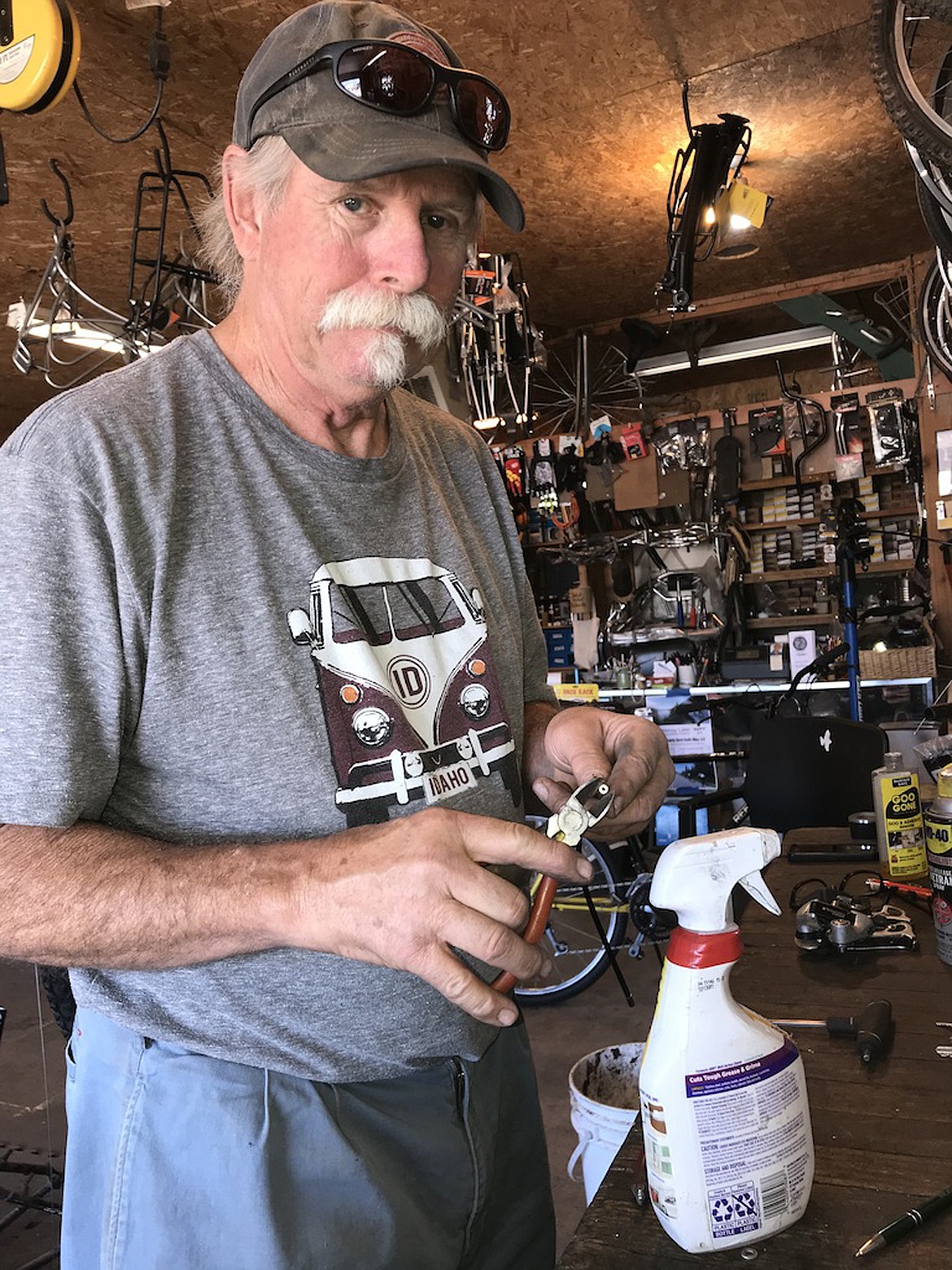 (Photo by  SUSAN DRINKARD) 
 Dan Shook, wearing a decidedly cool T-shirt, is one of the owners at Bonner County Bicycles. He says the bike shop owners repair all kinds of bikes, even those in big distress.
