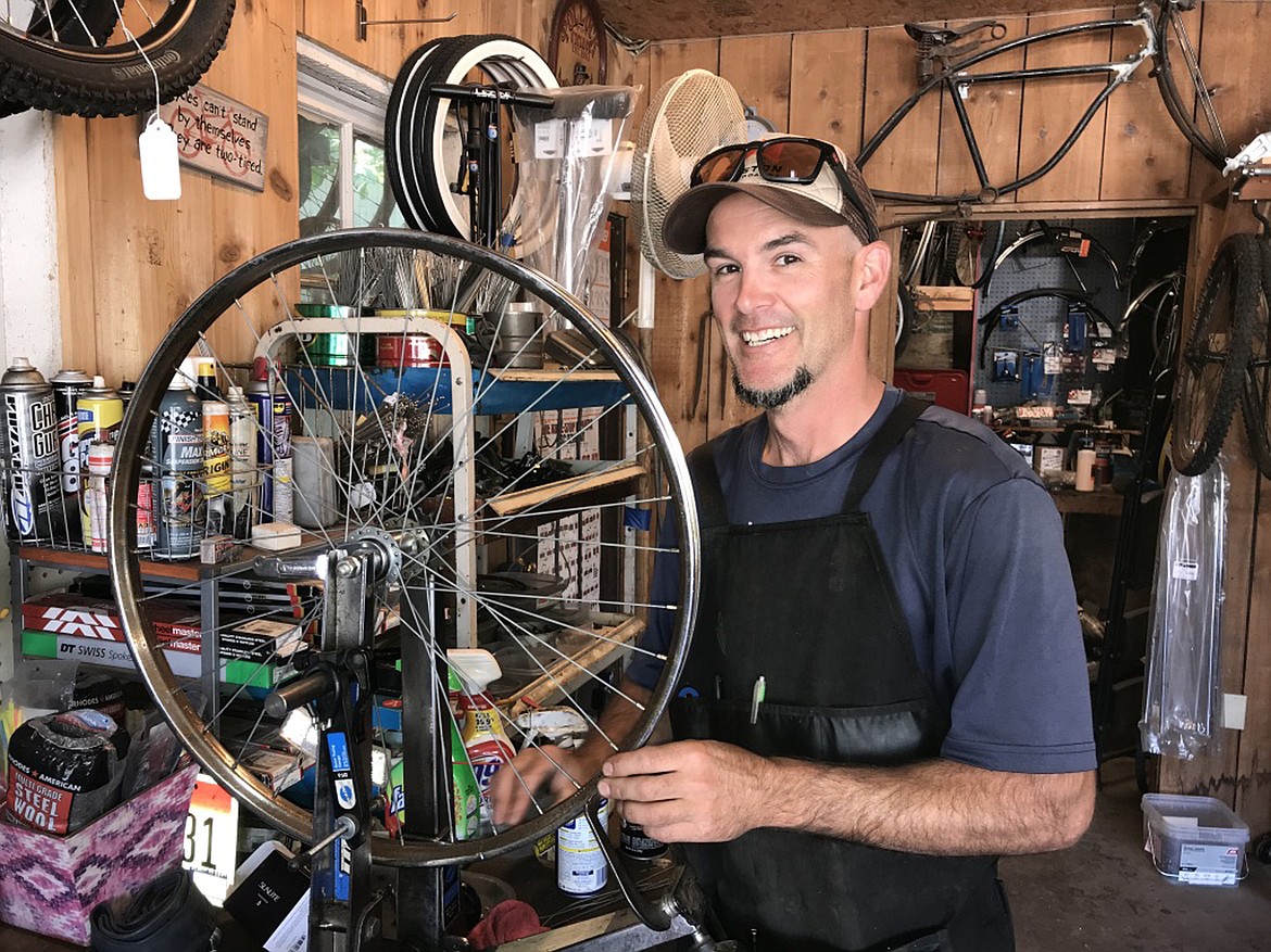Dan Shook shows two unusual bikes he restored that were once used by Olympic training teams in Guatemala and originally made by mechanical engineer Robert Phillips. Tim Piehl repairs a bicycle tire at Bonner County Bicycles behind Horizon Bank. Piehl, Dave Reisenauer and Dan Shook, owners, do righteous work — recycling as many old bikes as they get their hands on.