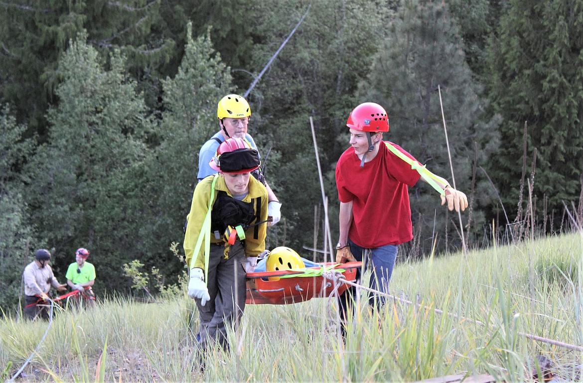 Volunteers practice their rope rescue skills