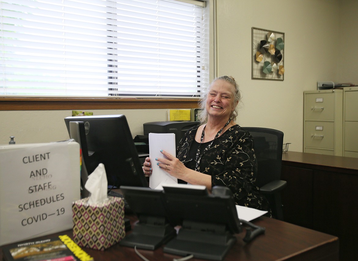 Linda Johnson, who works in billing at Tesh in Coeur d’Alene, is cheery and happy to return to the office Monday morning after COVID-19 closures.