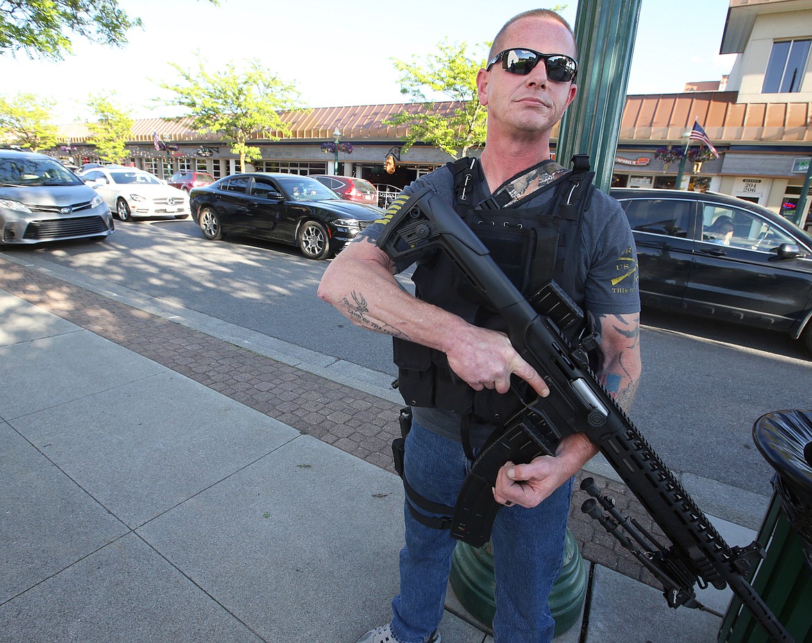 BILL BULEY/Press 
 Dan Carson stands ready to provide security for downtown Coeur d'Alene businesses on Monday evening.