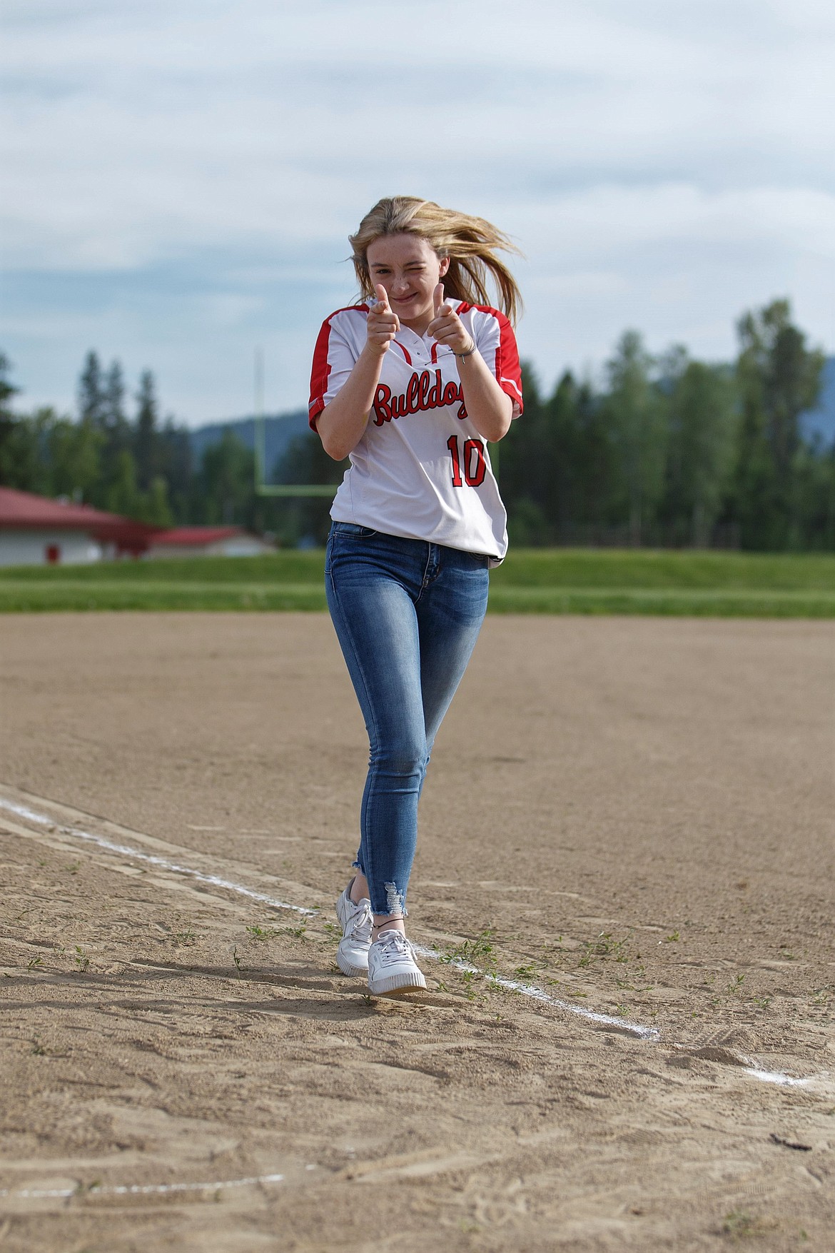 (Photo courtesy of JASON DUCHOW PHOTOGRAPHY) 
 Senior Paige Lanie celebrates after crossing home plate during Sandpoint softball's Senior Night on Saturday.