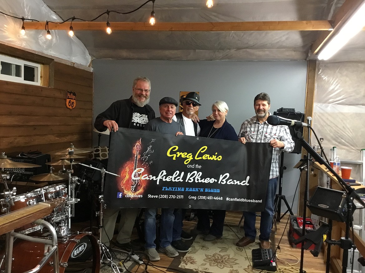 From left, Cary Sovereign, Steve Honig, Greg Lewis, Teri Grubbs and Randy Siers of Greg Lewis and the Canfield Blues Band played a neighborhood concert Sunday that brought in food and funds for the local food bank and humane society.