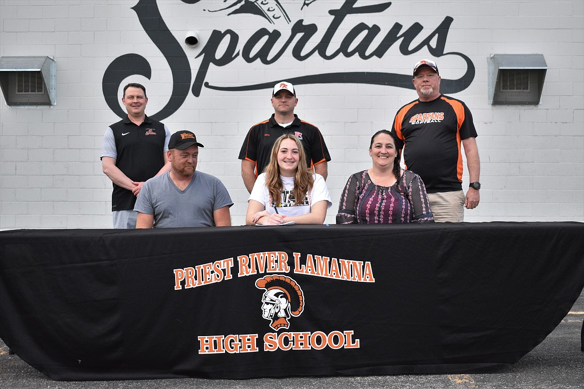 Natalie Randolph announces her commitment to play softball at Northland College in Ashland, Wisconsin, last Thursday in the Priest River High School parking lot. Pictured in the front row (from left): Natalie’s dad, Kirk, Natalie and her mom, Jessica. Back row: Athletic Director Matt George (left), softball head coach Rob DeMent and pitching coach Ron Kruse.