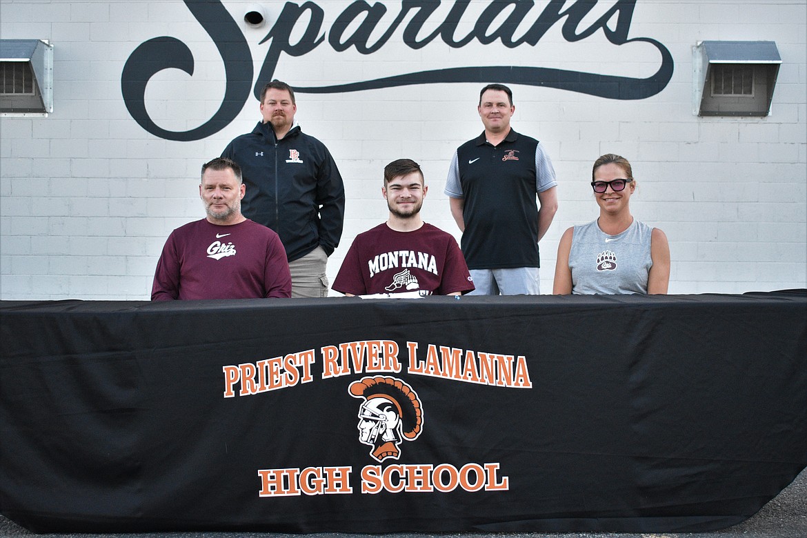 Teagun Holycross announces his commitment to run track at the University of Montana last Thursday in the Priest River High School parking lot. Pictured in the front row (from left): Teagun’s dad, Travis, Teagun and his mom, Janell. Back row: track and field coach Jared Hughes (left) and Athletic Director Matt George.