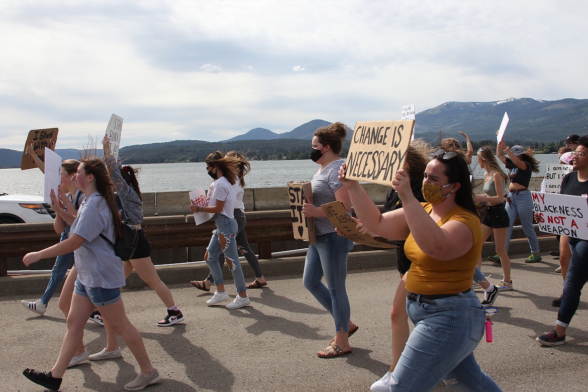 (Photo by KEITH KINNAIRD) 
 Demonstrators on the bridge.