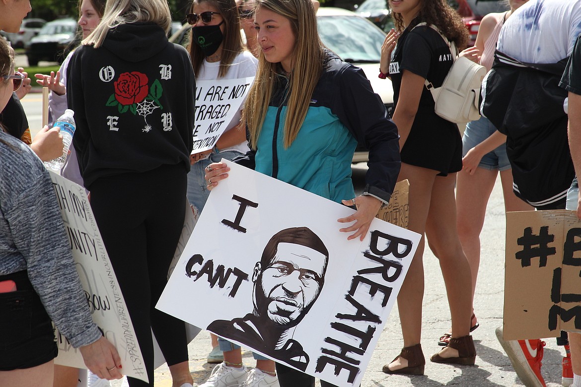 (Photo by KEITH KINNAIRD) 
 A protester with poster of an image of George Floyd.