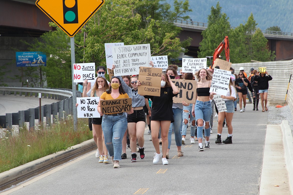 (Photo by KEITH KINNAIRD) 
 Protesters make their way down the bike path next to U.S. Highway 95.