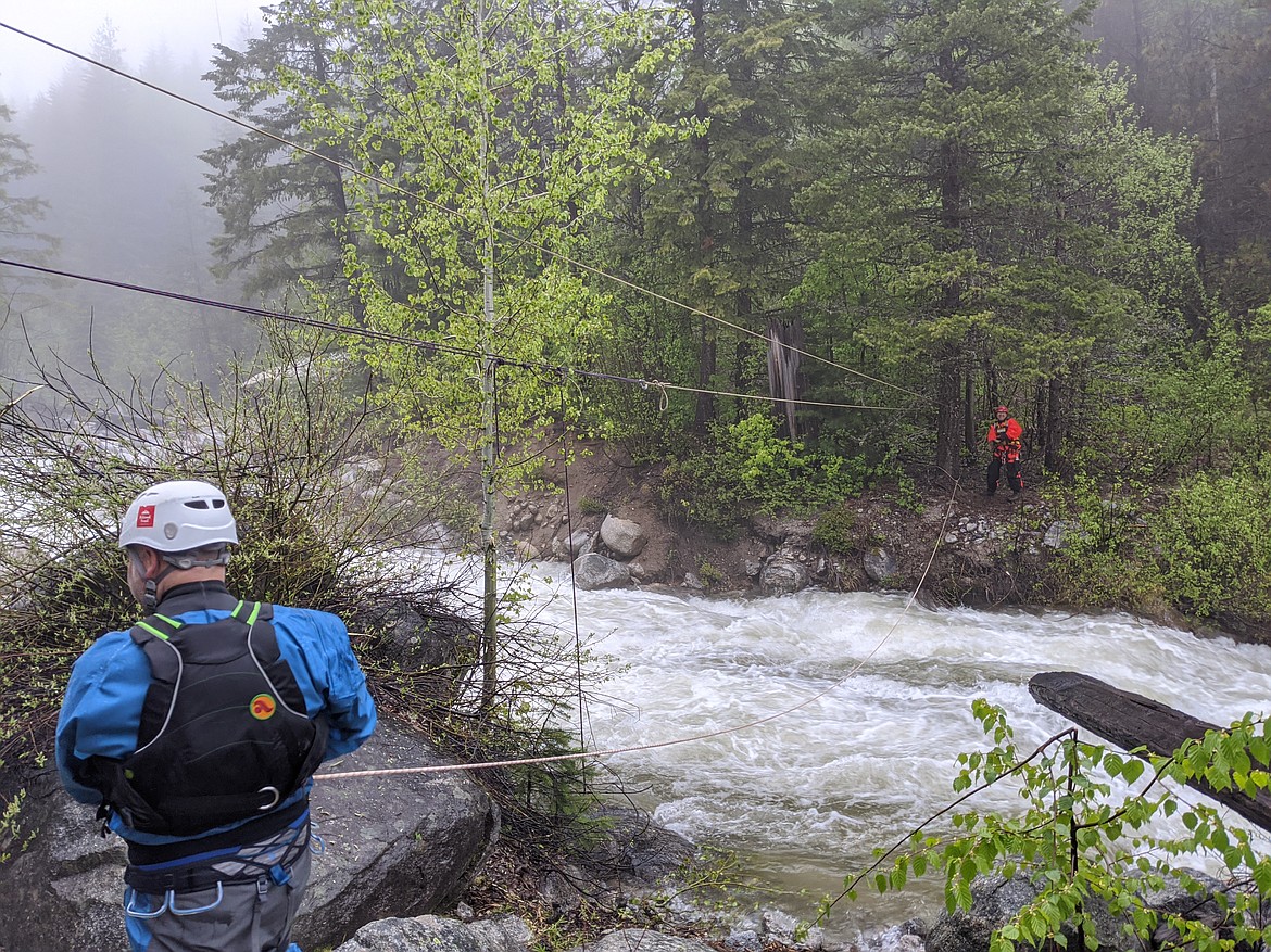 (Courtesy photo) 
 In the blue jacket and white helmet is BSDRT rescuer Pat Bennett, working across the stream in orange is BSDRT rescuer Adam Reeves, as they set up the rescue highline across McCormick Creek.