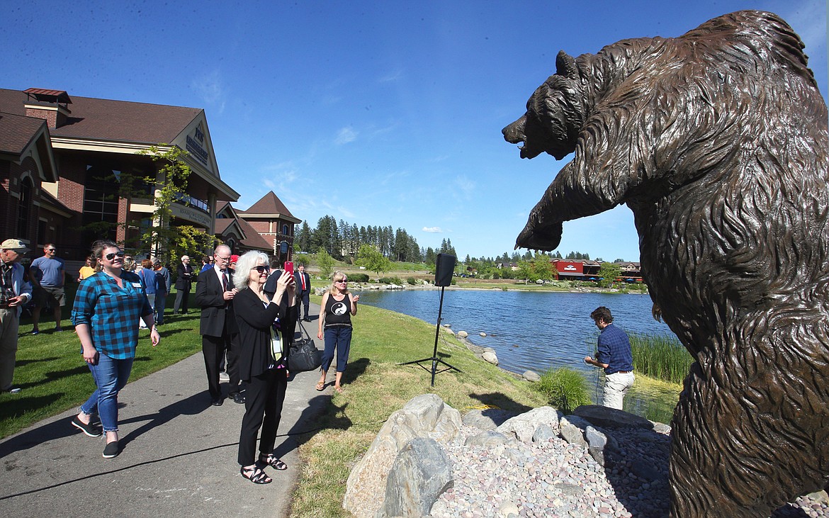BILL BULEY/Press 
 People get a closer look at the grizzly bear statue unveiled at Riverstone on Wednesday.
