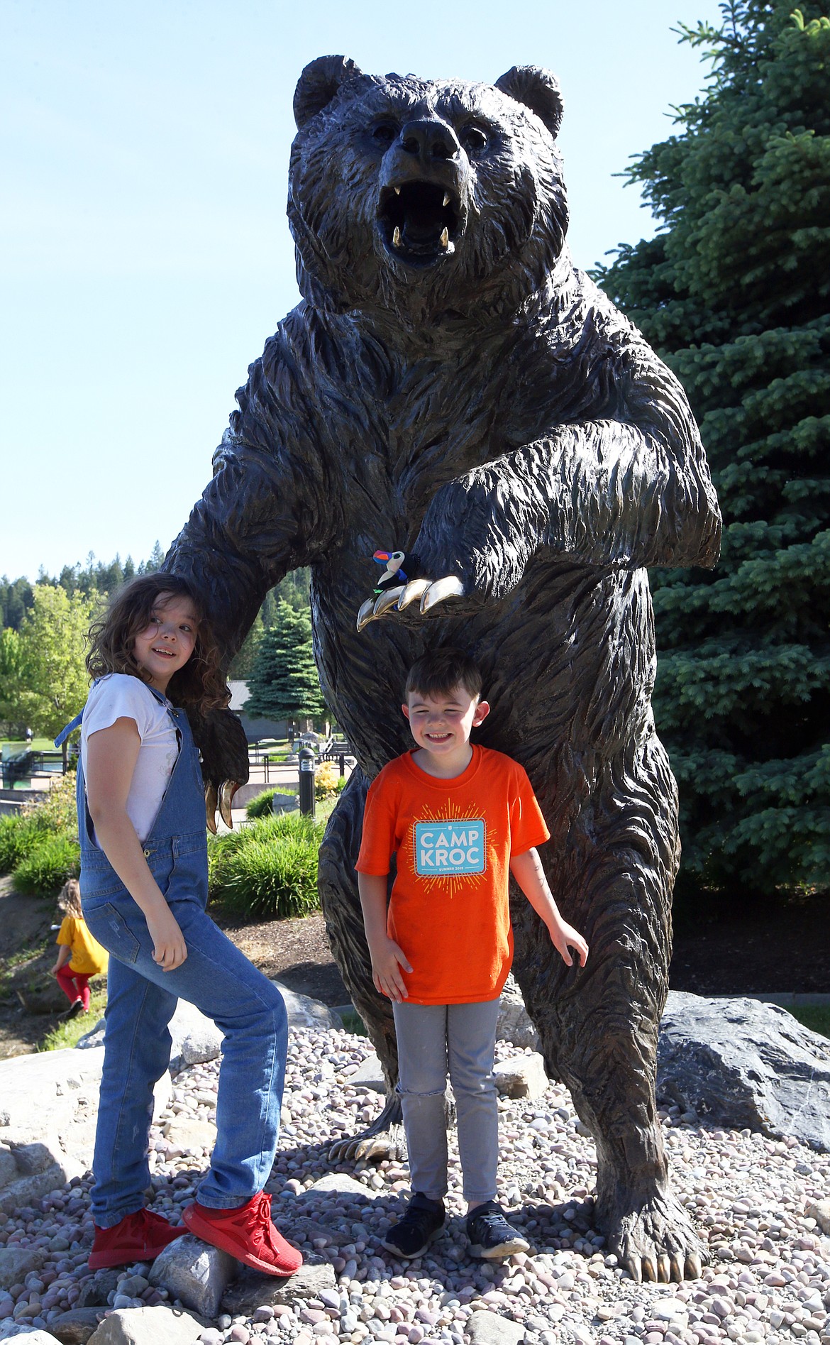 Simon and Francesca Blake pose by the bronze grizzly bear statue unveiled Wednesday at Riverstone.