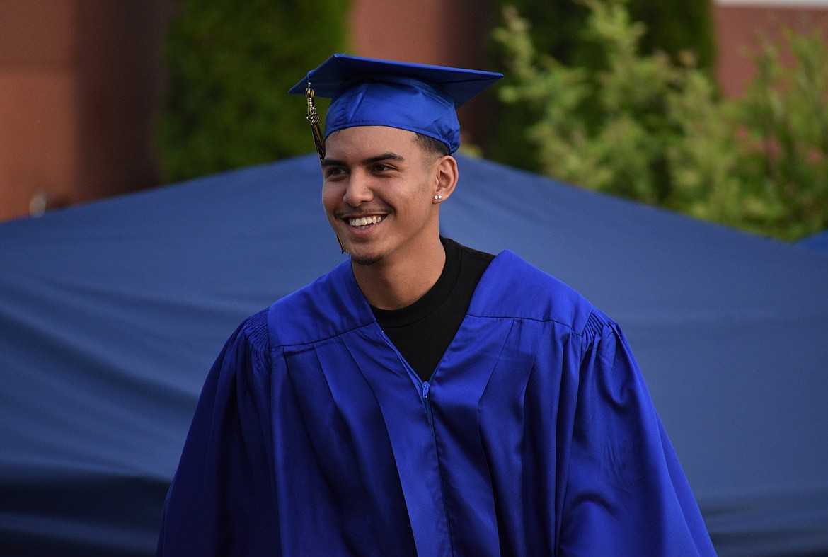 (Photo by DYLAN GREENE) 
 Denzel Kailang smiles as he walks on stage to receive his diploma Wednesday.
