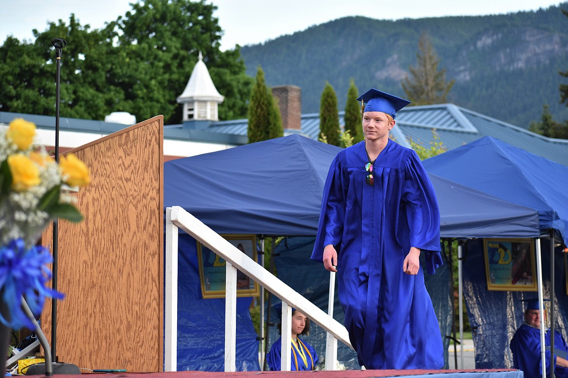 (Photo by DYLAN GREENE) 
 Isaac Steele walks on stage to receive his diploma.