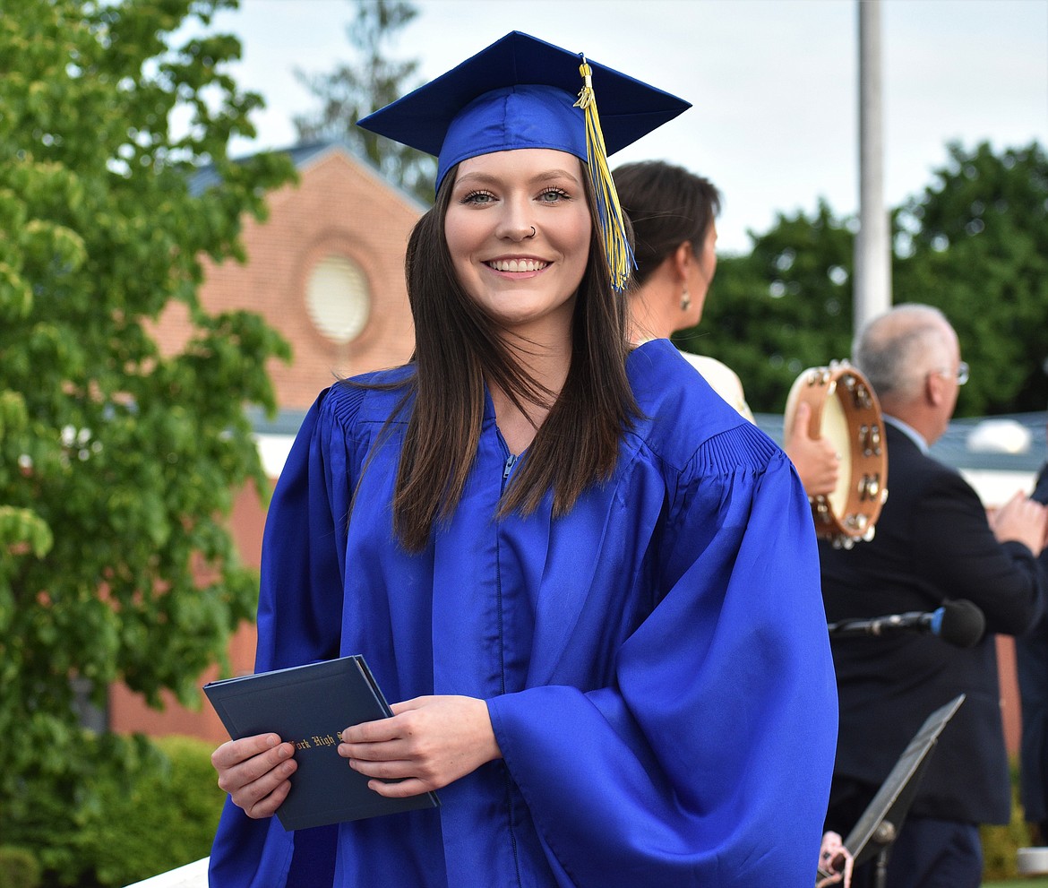 (Photo by DYLAN GREENE) 
 Madeline Reuter walks off the stage after receiving her diploma.