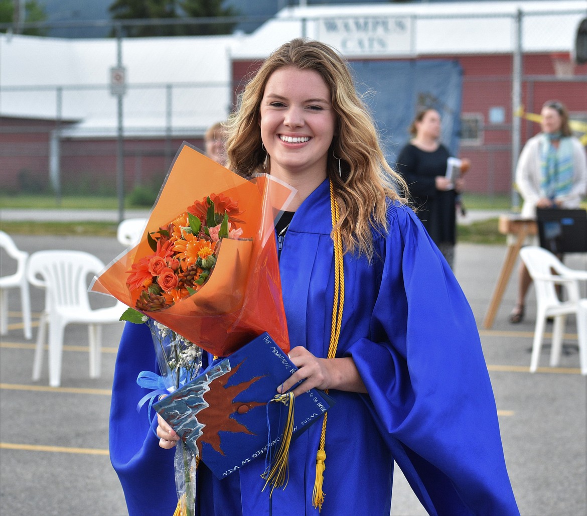 (Photo by DYLAN GREENE) 
 Sophie McMahon can't hold back a smile after the CFHS graduation ceremony.