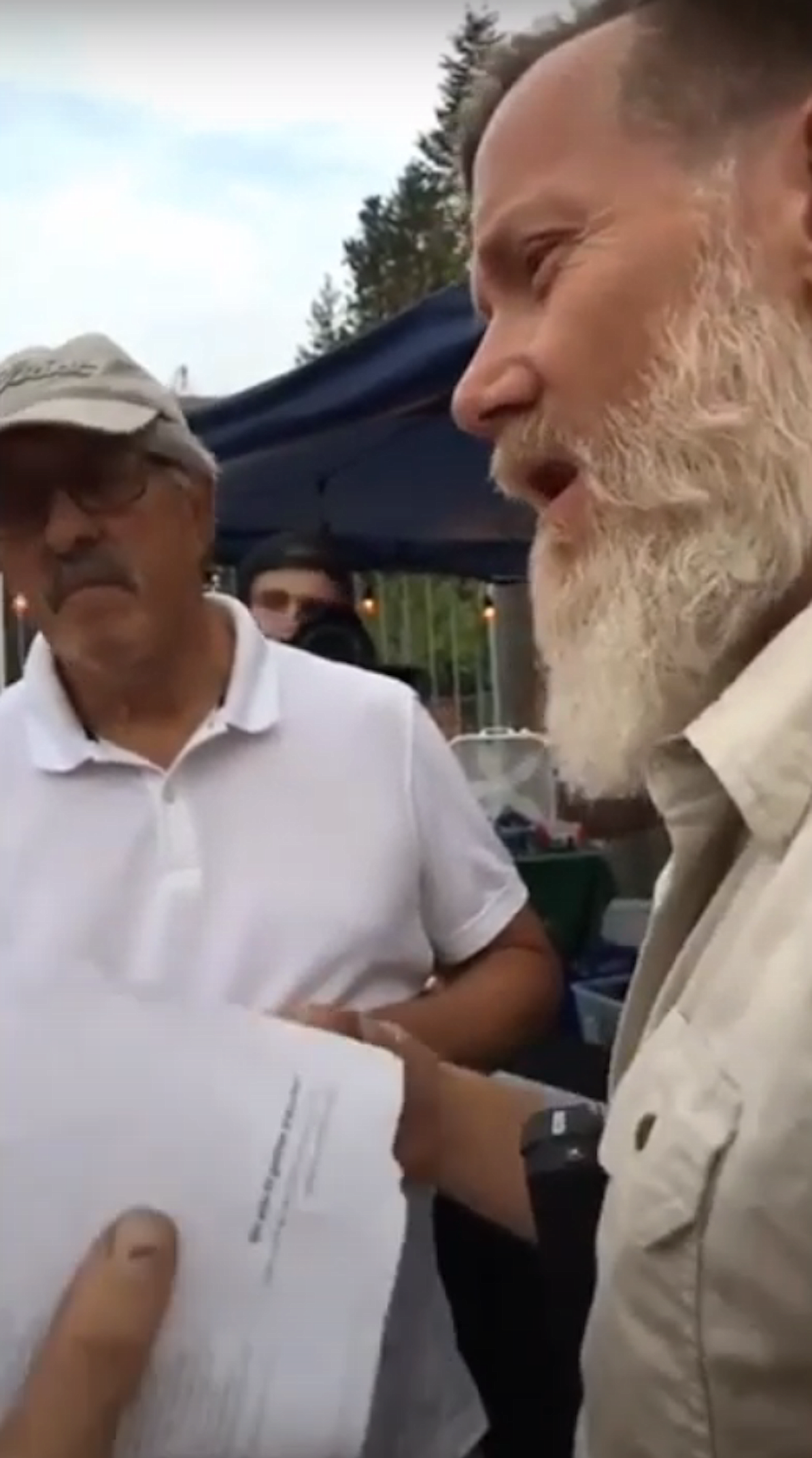 (Image via YOUTUBE) 
 In this screen grab, Scott Herndon (right) attempts to convince Sandpoint City Attorney Will Herrington he should be allowed to enter the Festival at Sandpoint while carrying a firearm in 2019.