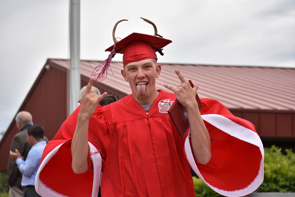 Carter Envik crosses the stage with antlers on his cap.